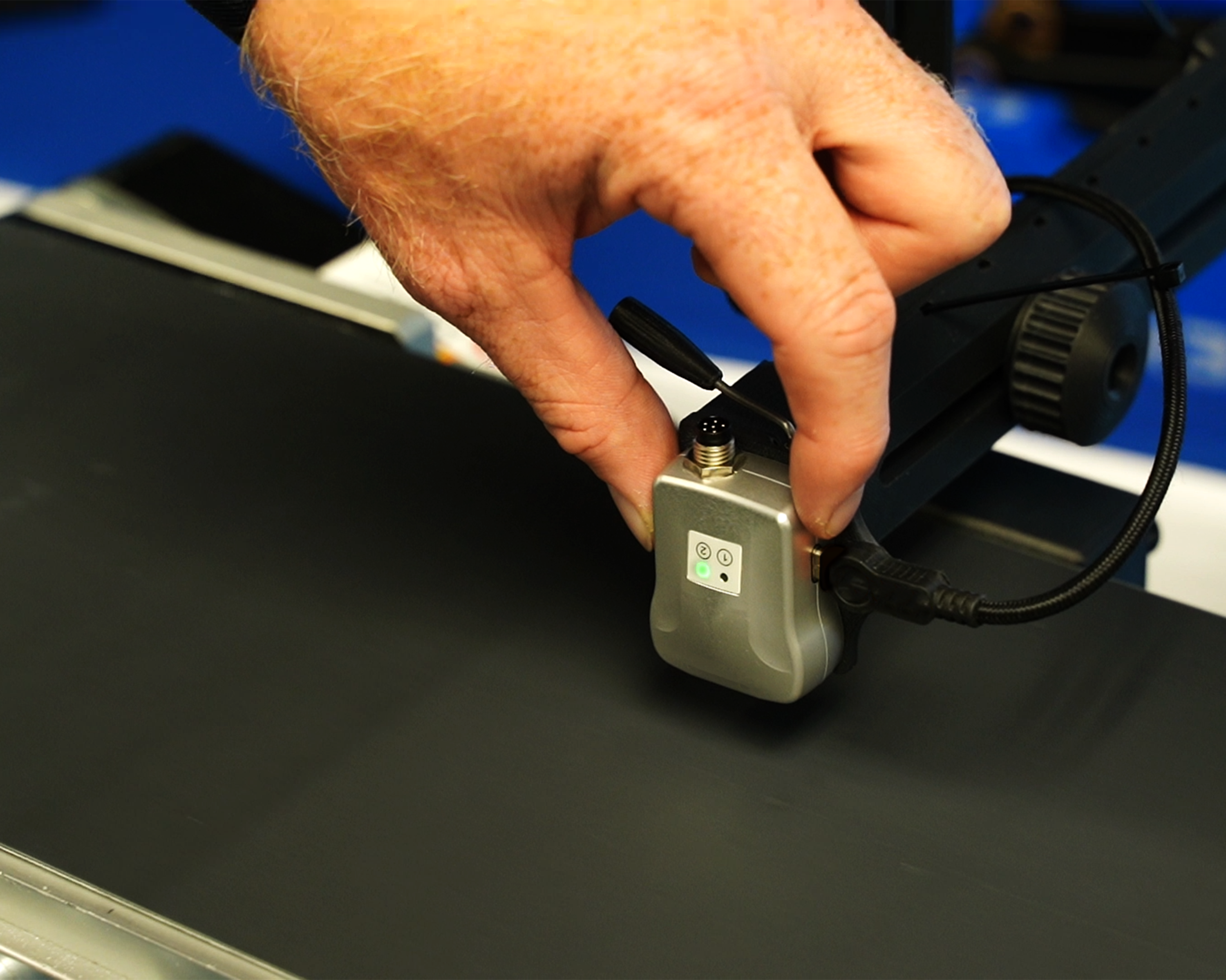 LP1 on conveyor with hand